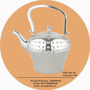 silver tea pot with hammer dots